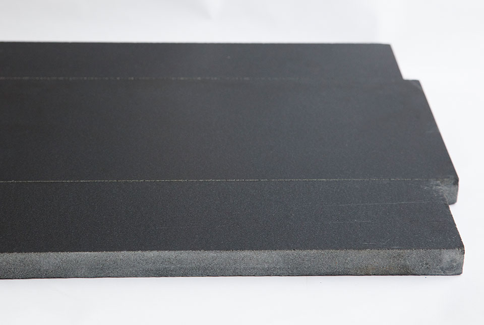 Close up of Norstone Ebony Planc Large Format Tile with a polished finish